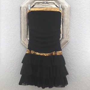 Black mini dress with gold accents
